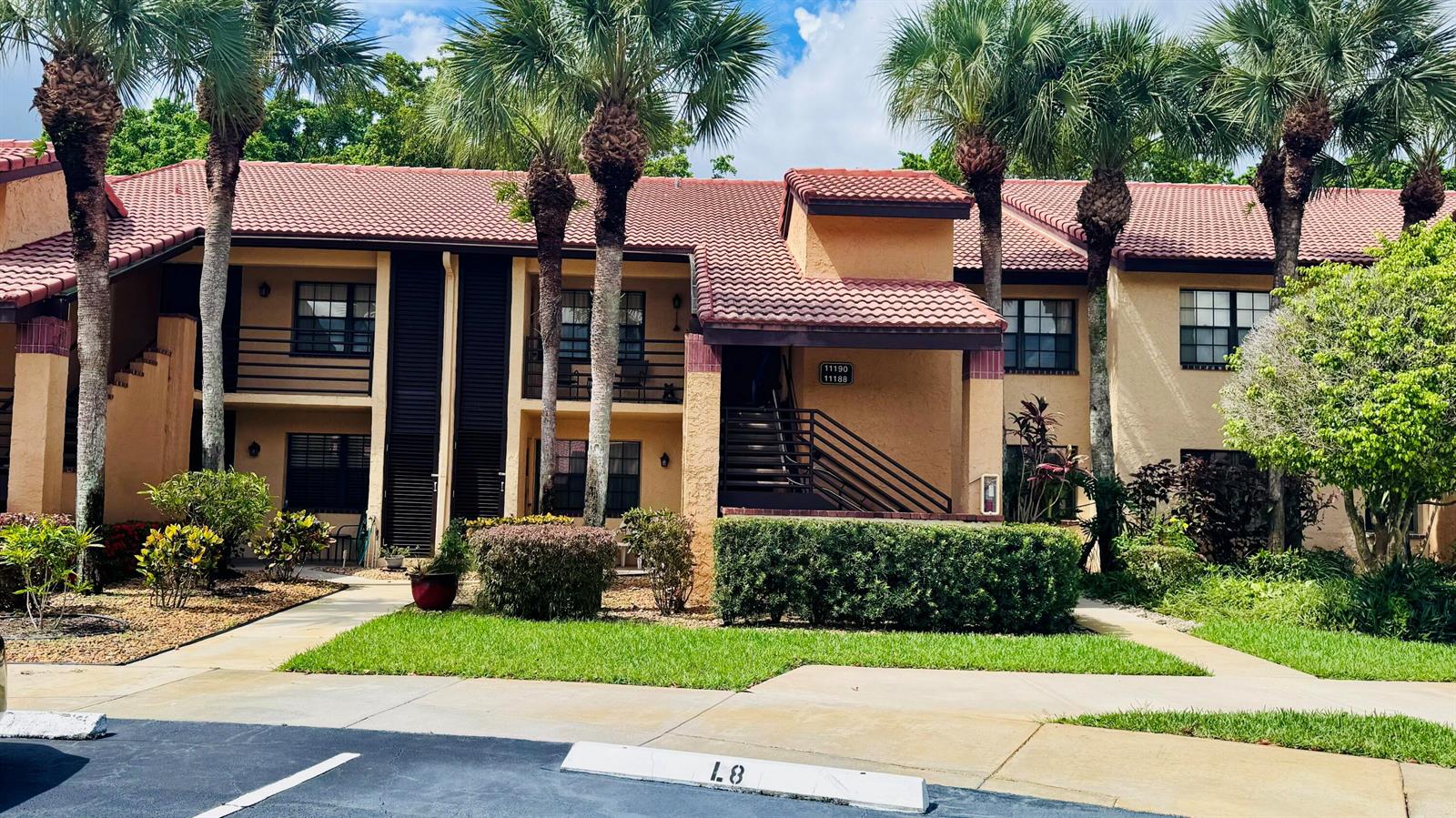 A two-story apartment building with a red tile roof, palm trees, and a parking space — 11190 Aspen Glen Drive, Boynton Beach FL 33437, BOYNTON BEACH, FL