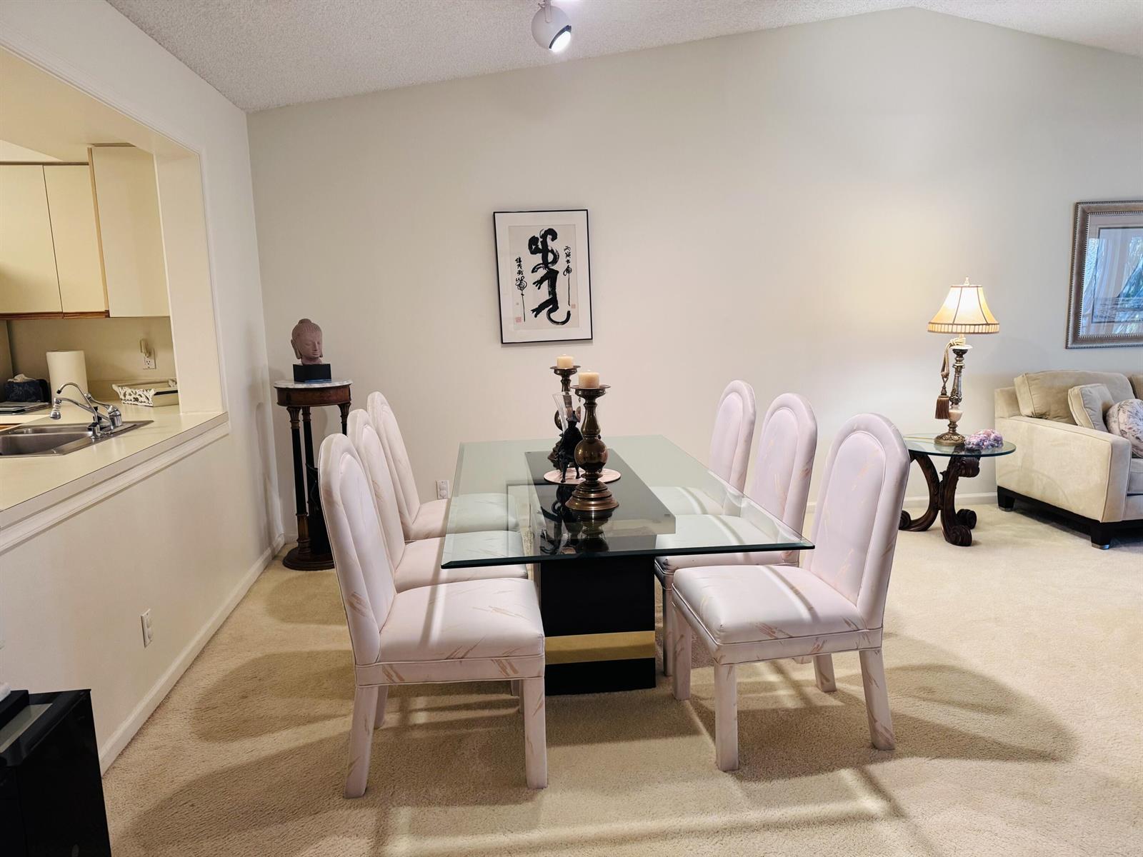 A dining room features a glass-topped table with six upholstered chairs and a pedestal base — 11190 Aspen Glen Drive, Boynton Beach FL 33437, BOYNTON BEACH, FL