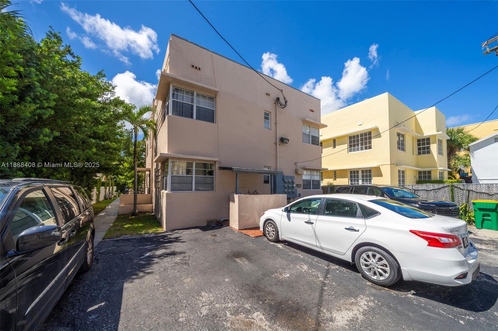 A two-story beige apartment building with a parking lot in front and a white car — 1329 Pennsylvania Ave, Miami Beach FL 33139, MIAMI BEACH, FL
