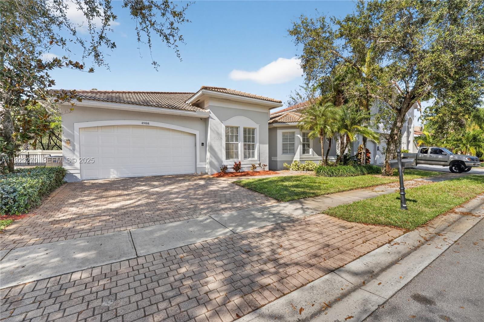 A single-story house with a brick paver driveway, a two-car garage, and mature landscaping — 4988 SW 183rd Ave, Miramar FL 33029, MIRAMAR, FL