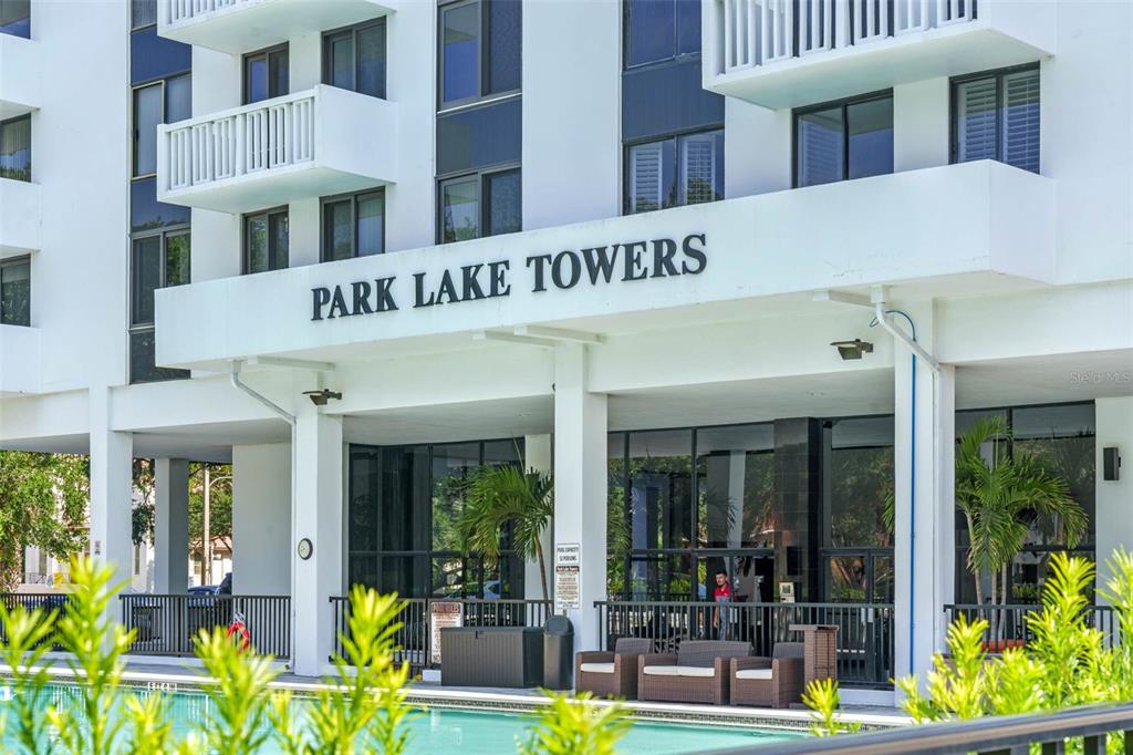 The exterior of Park Lake Towers features a white facade, a covered entrance, and a pool — 400 E COLONIAL DRIVE UNIT 608, ORLANDO, FL