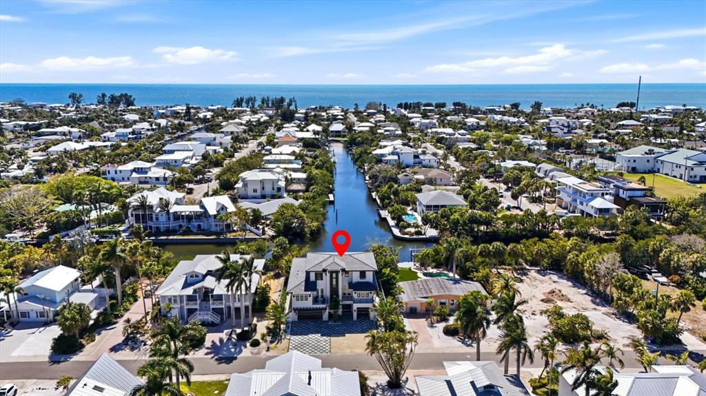 An aerial view shows a multi-story house with a red location pin on a canal — 319 TARPON STREET, ANNA MARIA, FL