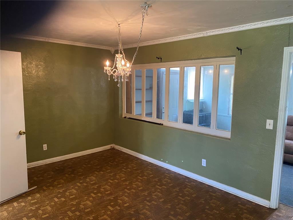 A kitchen features white cabinets, stainless steel appliances, a double sink, and light-colored countertops — 1040 HAMPTON ROAD, DAYTONA BEACH, FL