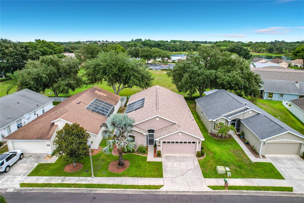 An aerial view shows a suburban house with a tan roof and a palm tree — 4178 CANNES AVENUE, LAKE WALES, FL