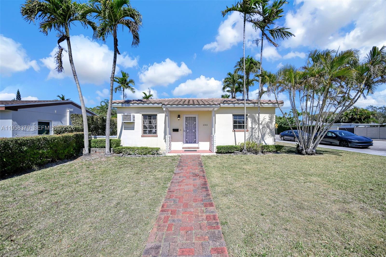 A single-story house with a brick walkway and palm trees in the front yard — 6303 SW 43rd St, South Miami FL 33155, SOUTH MIAMI, FL