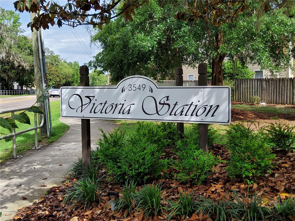 A white sign reading Victoria Station stands on two wooden posts near a sidewalk — 3510 SW 30TH WAY UNIT 156, GAINESVILLE, FL