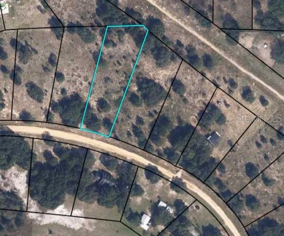 An aerial map view shows a vacant, rectangular lot outlined in blue along a road — 5738 N CRATER LAKE CIRCLE, KEYSTONE HEIGHTS, FL