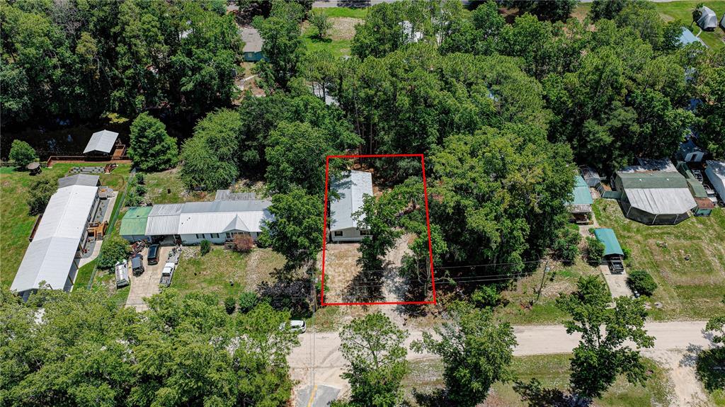 An aerial view shows a single-story house outlined in red, surrounded by trees and neighboring properties — 118 WATERWAY DRIVE, SATSUMA, FL