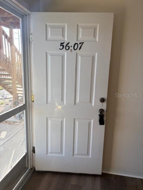 A white front door with the number 5607 is visible inside a home entryway — 5607 67TH AVENUE N UNIT 314, PINELLAS PARK, FL