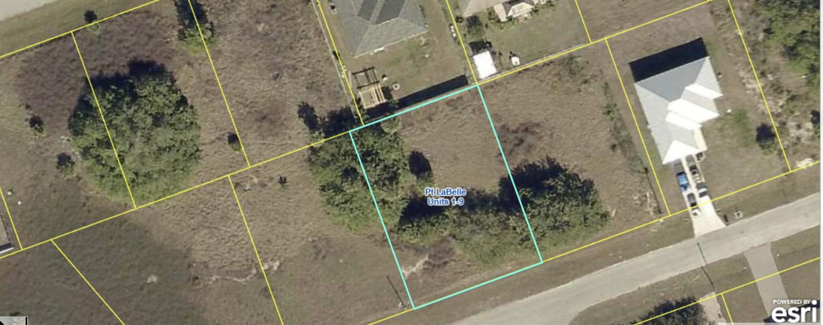 This is an aerial map view showing a vacant rectangular lot outlined in light blue — 7058 Calder Circle, FL 33935, FL