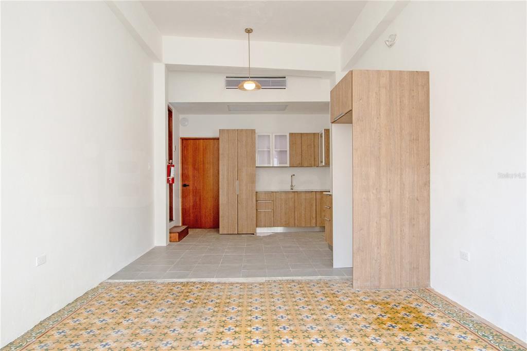 An interior view shows a kitchen with wood-toned cabinets and a patterned tile floor — 319 RECINTO SUR STREET UNIT 2, SAN JUAN, PR