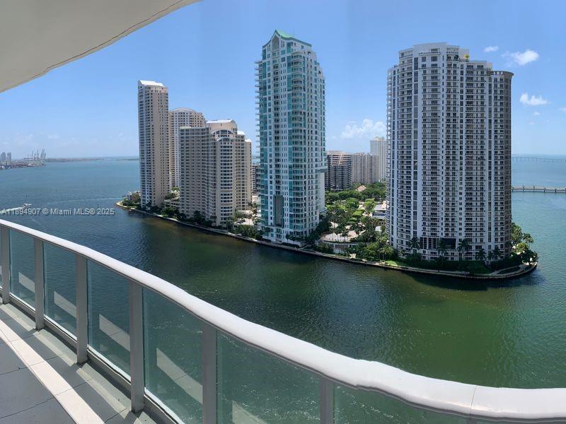 A balcony view overlooking a bay with several high-rise residential buildings — 300 S Biscayne Blvd # 1908, Miami FL 33131, MIAMI, FL