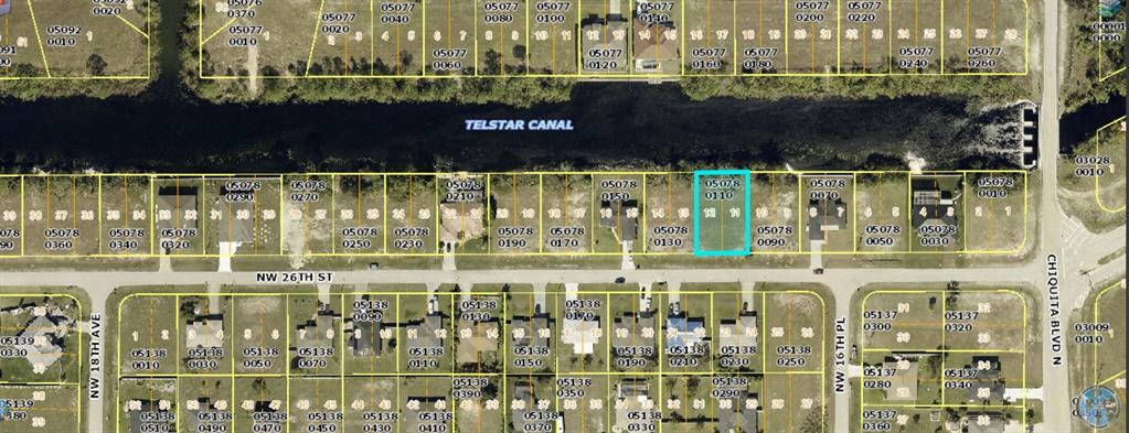 This is an aerial map showing a vacant lot highlighted in blue along a canal — 1623 NW 26TH STREET, CAPE CORAL, FL