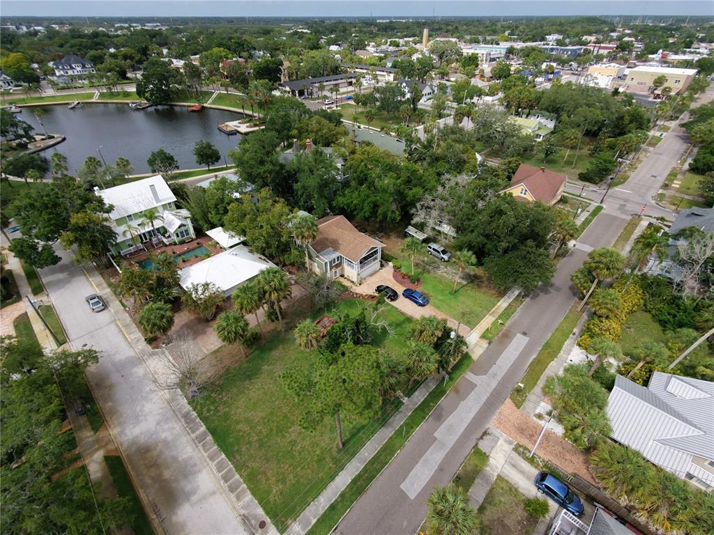 An aerial view shows a residential neighborhood with houses, a lake, and streets — LEMON STREET, TARPON SPRINGS, FL