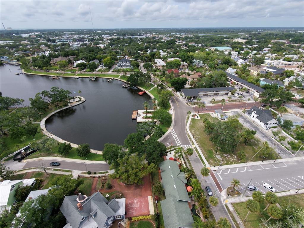 An aerial view shows a waterfront park with a pier, surrounding streets, and residential buildings — LEMON STREET, TARPON SPRINGS, FL