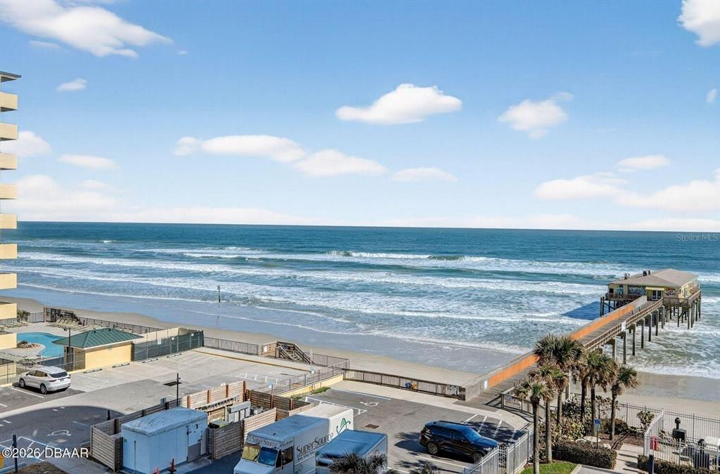 An elevated view of a beach, ocean, and pier from a building balcony — 3703 S ATLANTIC AVENUE UNIT 504, DAYTONA BEACH SHORES, FL