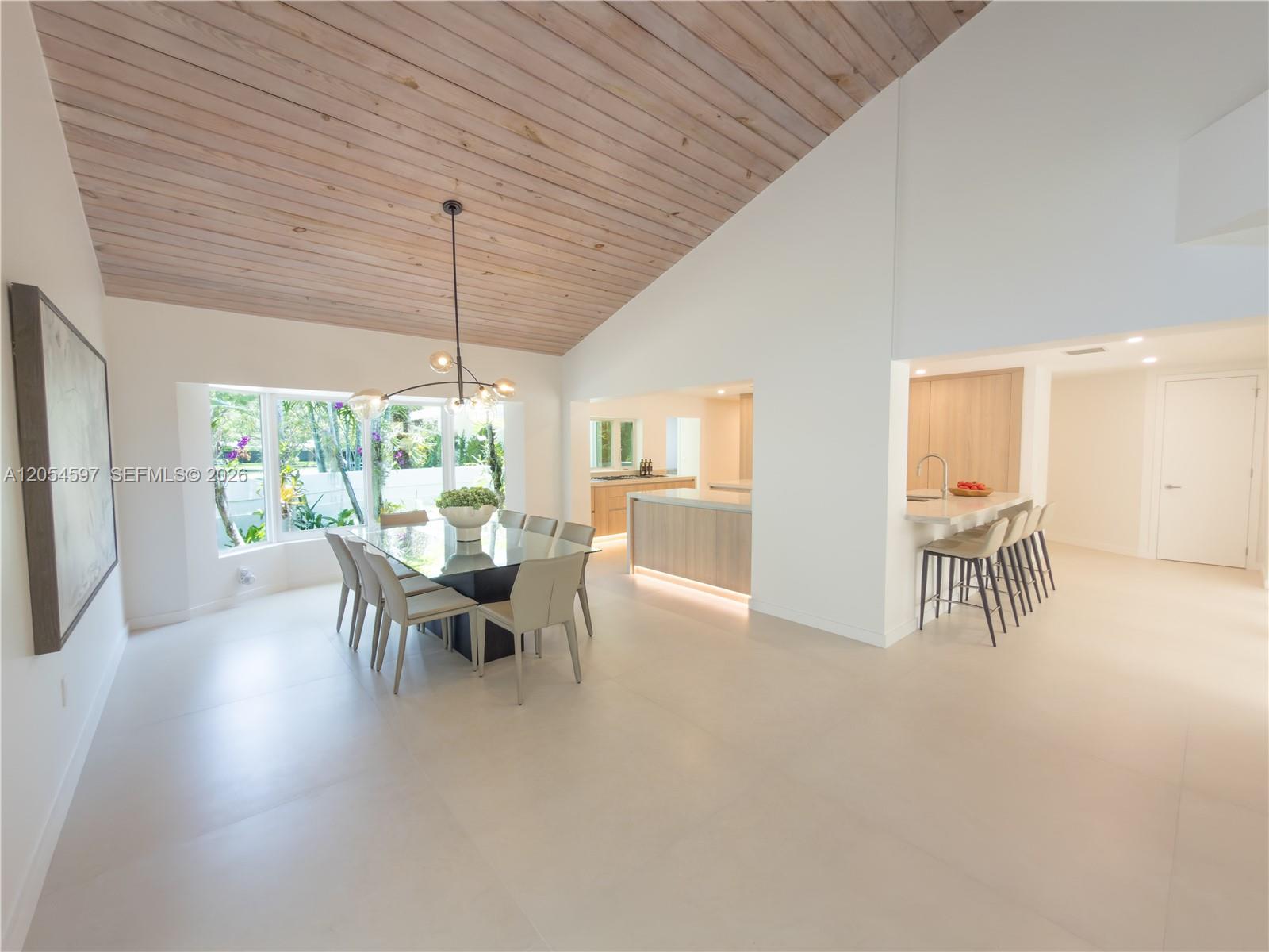 A dining area and kitchen feature a vaulted wood-plank ceiling and light-colored tile floors — 11450 SW 92nd Ct, Miami FL 33176, MIAMI, FL