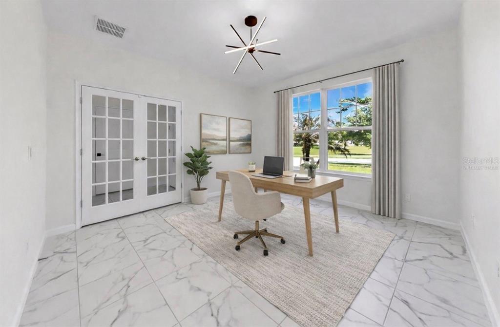 A home office features white marble-look tile floors, a wooden desk, and French doors — 12317 BAY ESTUARY BEND, RIVERVIEW, FL