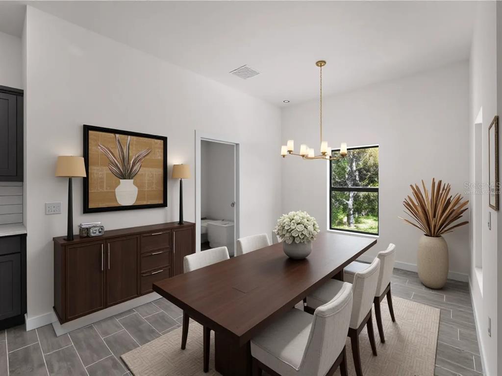 This is a virtually staged dining room with a dark wood table, chairs, and sideboard — 17339 ELMWOOD AVENUE, PORT CHARLOTTE, FL