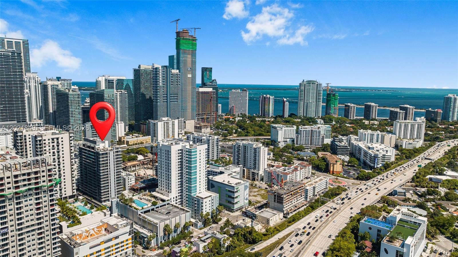 An aerial view shows a high-rise building marked with a red pin in Miami — 1010 SW 2nd Ave # 1608, Miami FL 33130, MIAMI, FL