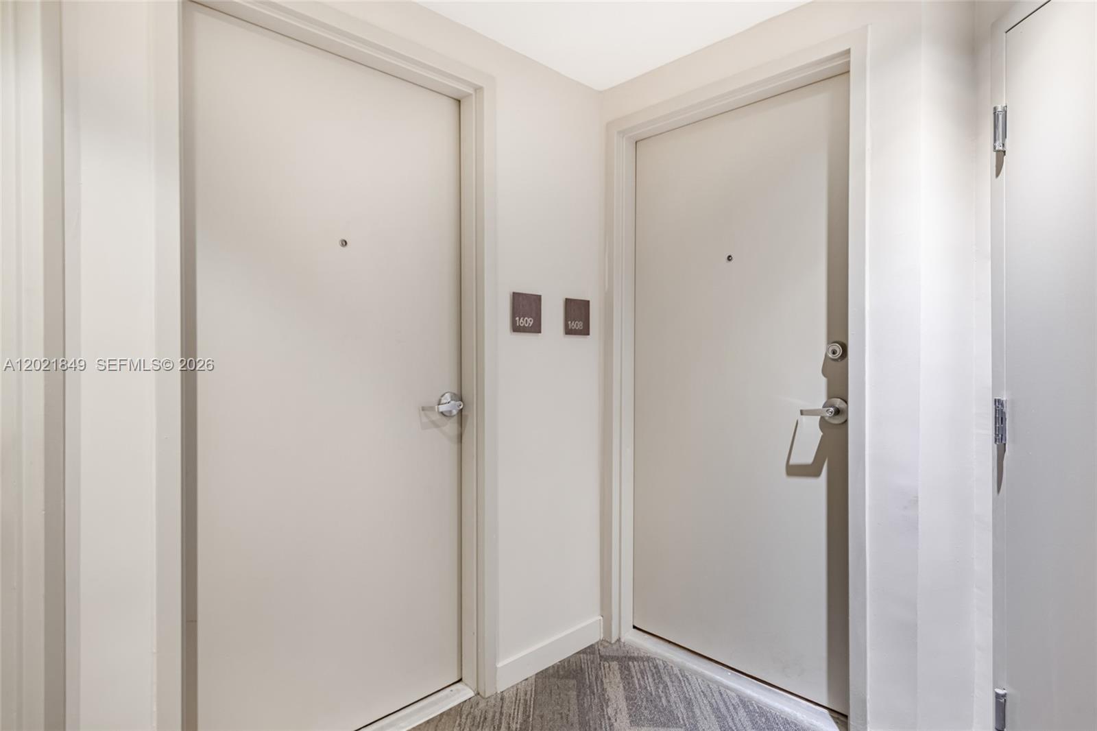 Two beige apartment doors with unit numbers 1609 and 1608 are set in a hallway — 1010 SW 2nd Ave # 1608, Miami FL 33130, MIAMI, FL