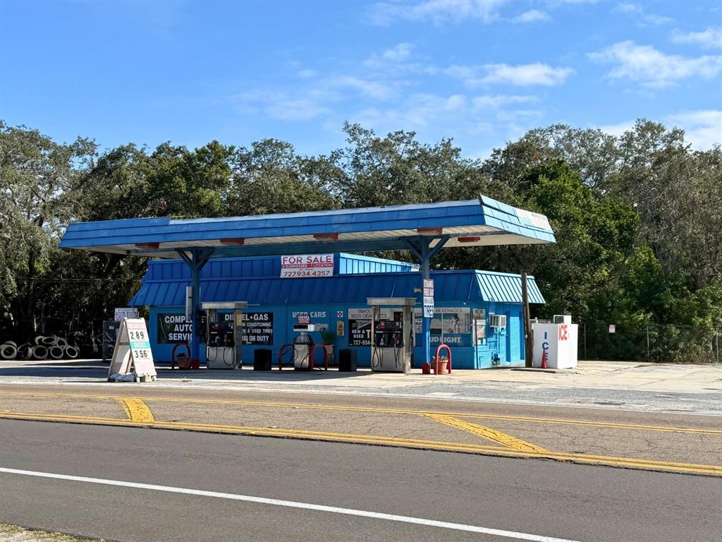 A blue gas station building with a large canopy stands beside a road — 1941 S PINELLAS AVENUE, TARPON SPRINGS, FL