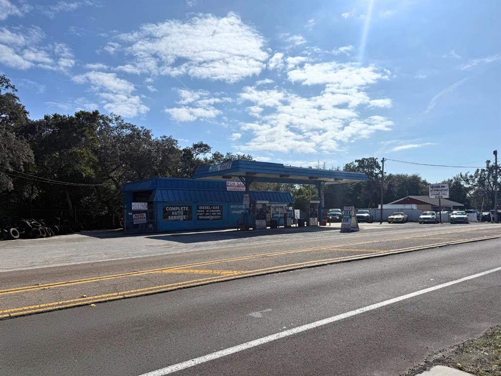 A blue gas station and auto repair shop sits along a road under a sunny sky — 1941 S PINELLAS AVENUE, TARPON SPRINGS, FL