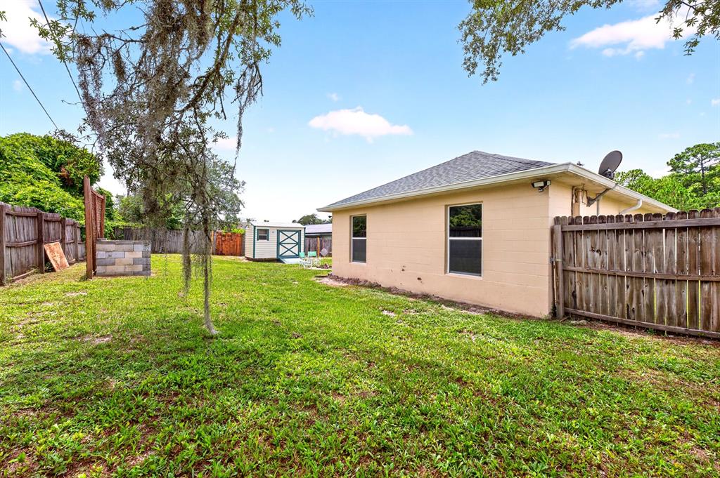 A kitchen features dark cabinets, stainless steel appliances, and granite countertops with a breakfast bar — 3147 UTAH DRIVE, DELTONA, FL
