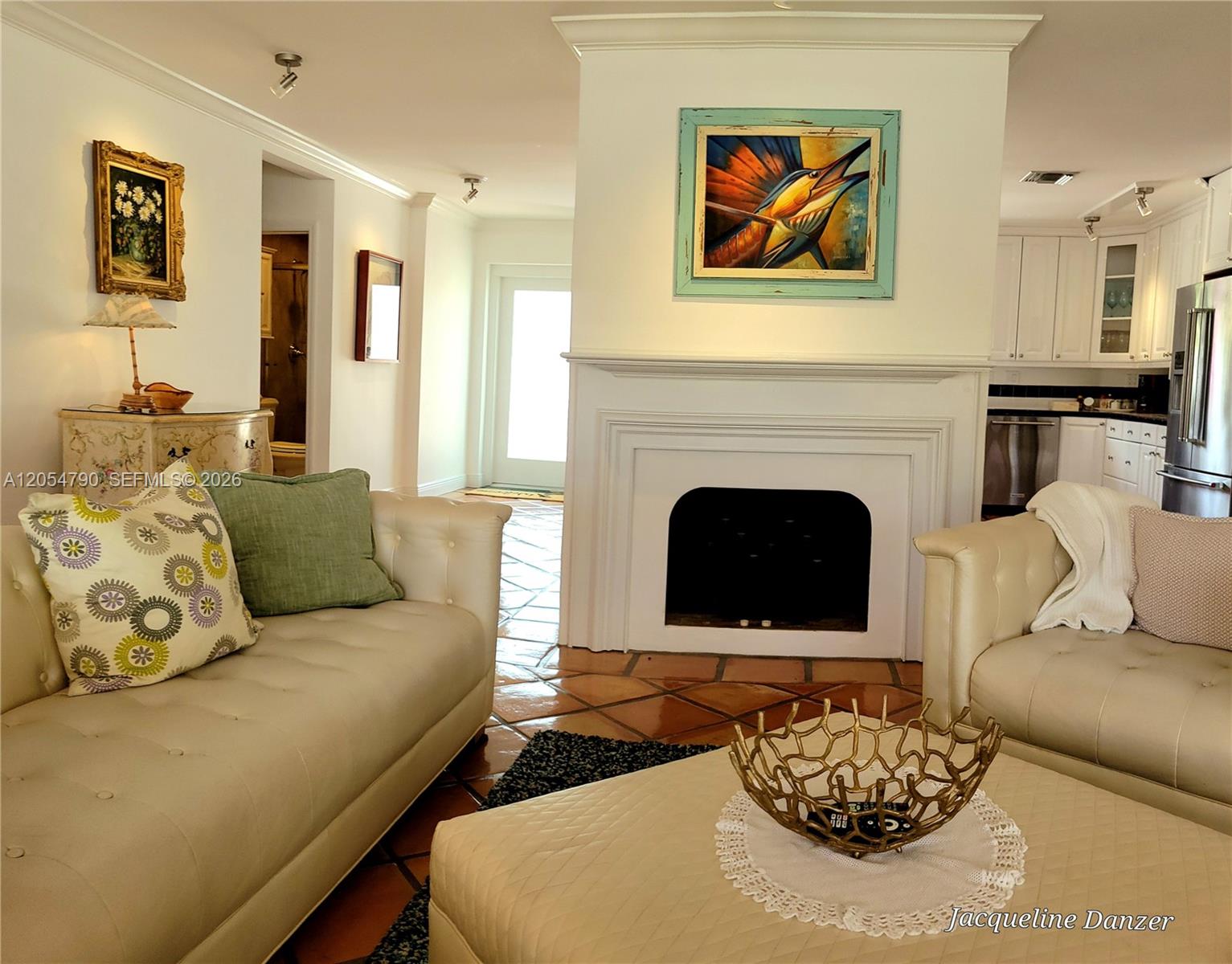 A living room features a fireplace, white sofas, and tile flooring — 2781 NE 23rd Ct # 2781, Pompano Beach FL 33062, POMPANO BEACH, FL