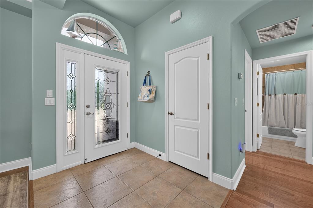 A dining room features a wooden table, woven chairs, a bench, and light blue walls — 3385 TESORO CIRCLE, NEW SMYRNA BEACH, FL