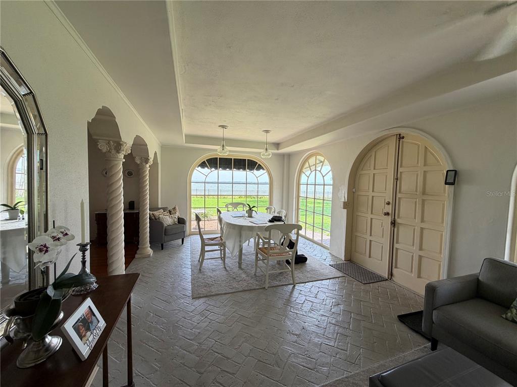 A two-story Mediterranean-style house with a red tile roof and a brick driveway — 801 LAKE SHORE DRIVE, LEESBURG, FL