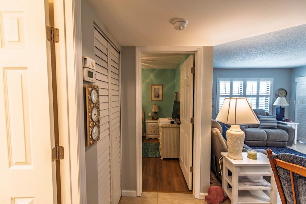 A hallway leads to a bedroom, with a living room visible to the right — 19505 QUESADA AVENUE UNIT RR202, PORT CHARLOTTE, FL