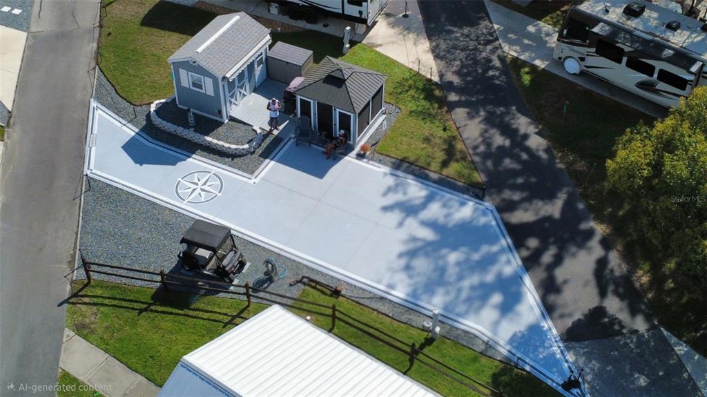 An aerial view shows a paved patio area with a compass rose design and gazebo — 2850 NE 103RD TERRACE, SILVER SPRINGS, FL