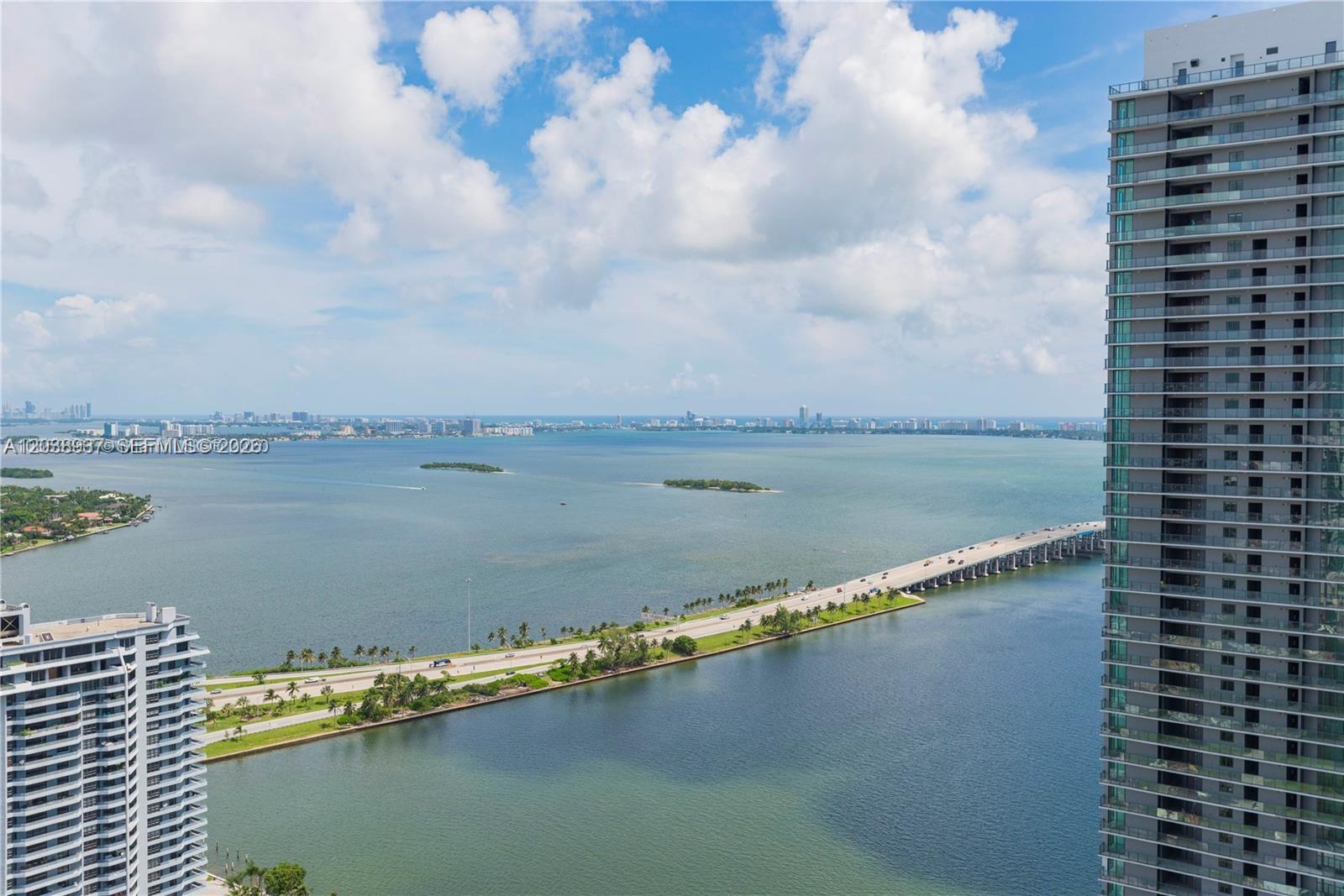 An aerial view shows a causeway connecting land masses across a bay near high-rise buildings — 501 NE 31st St # 3505, Miami FL 33137, MIAMI, FL