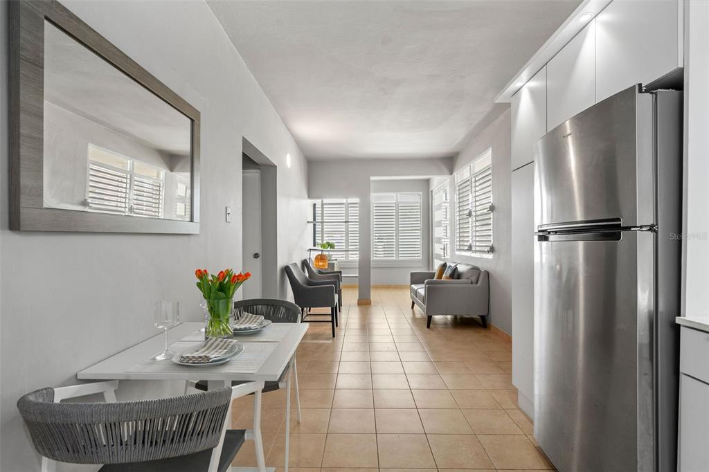 A kitchen and living area with tile floors, a dining table, and stainless steel appliances — 56 MARIA MOCZO UNIT 1, SAN JUAN, PR