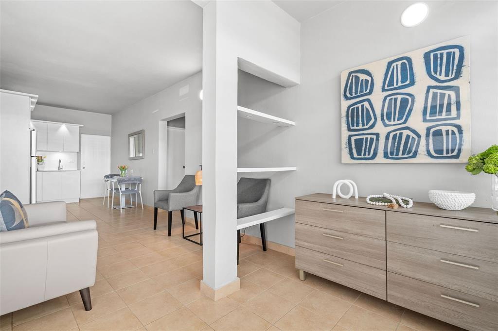 A living area features tile floors, a built-in shelf divider, and a wooden dresser — 56 MARIA MOCZO UNIT 1, SAN JUAN, PR