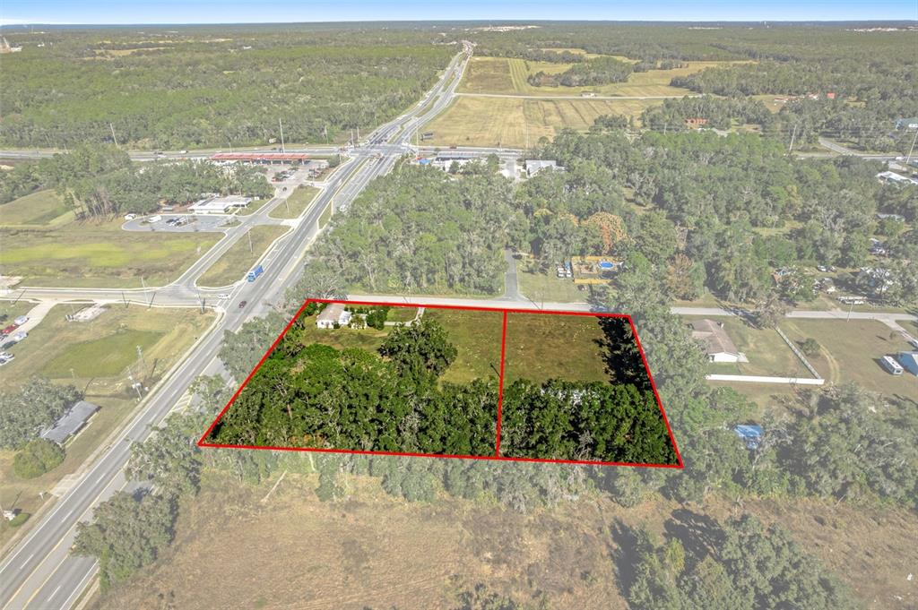 An aerial view shows two adjacent rectangular parcels of land with trees and a house — 3228 & 3164 W LAUREL STREET, LECANTO, FL