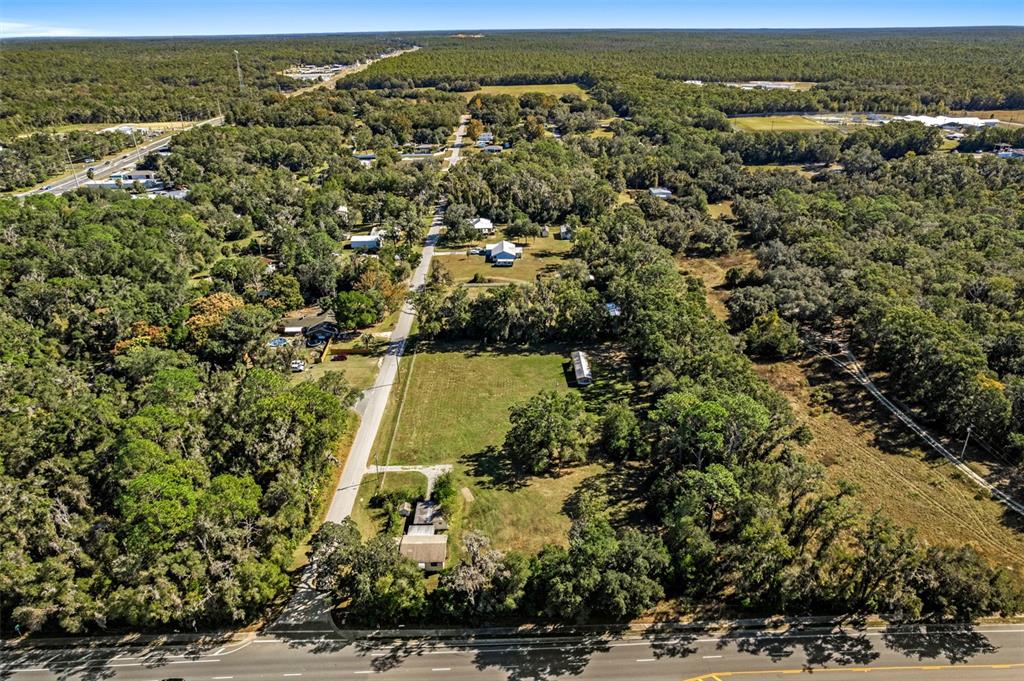 An aerial view shows a rural property with a house, a mobile home, and trees — 3228 & 3164 W LAUREL STREET, LECANTO, FL