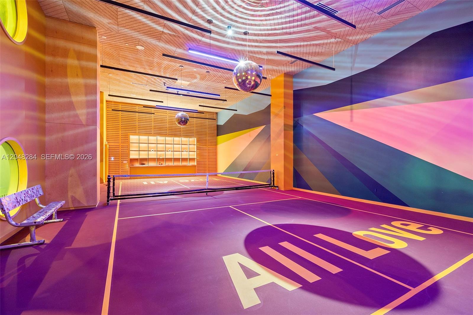 An indoor pickleball court features a purple floor with large lettering and disco balls overhead — 90 NE 32 # 514, Miami FL 33127, MIAMI, FL