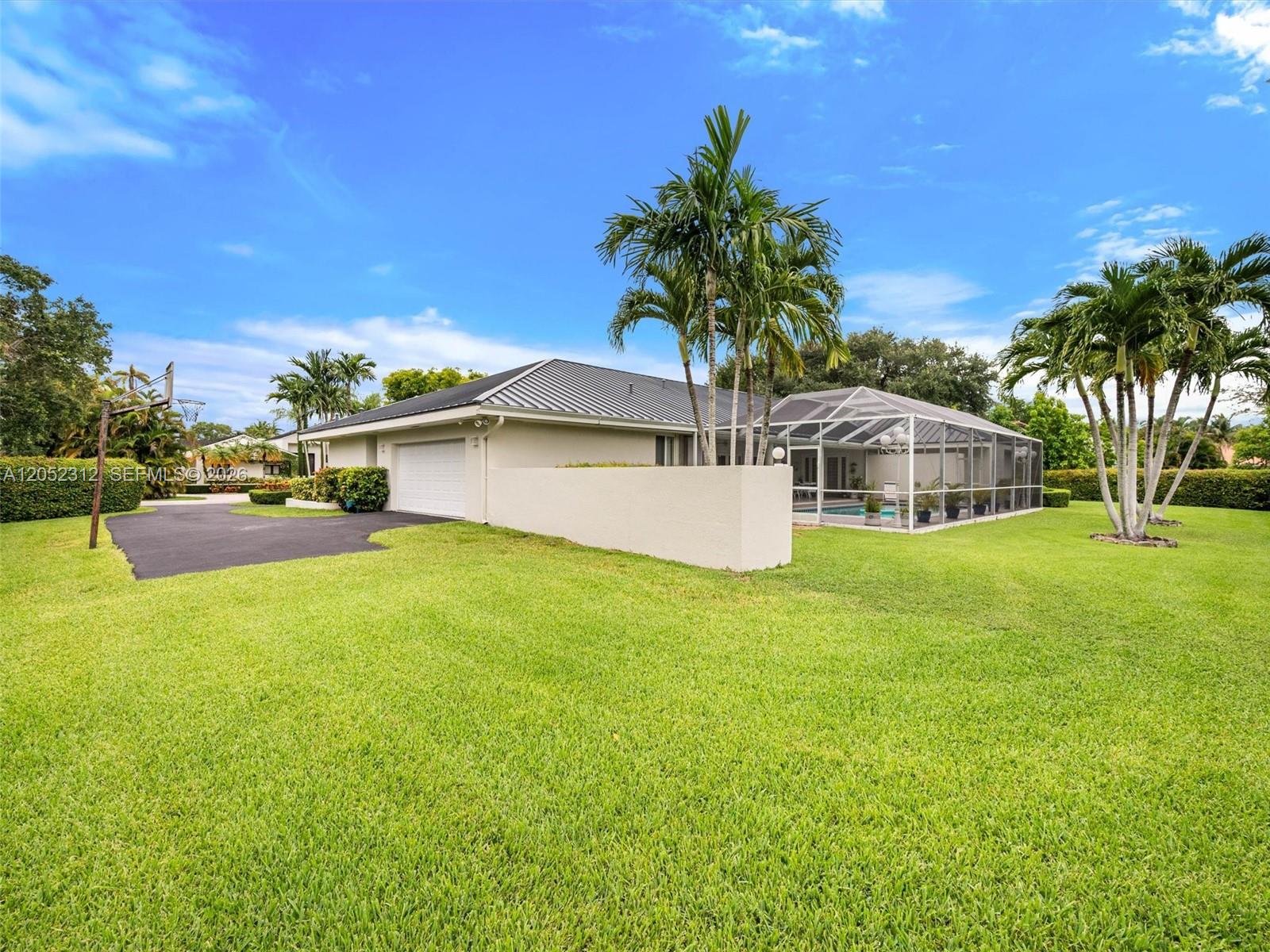 A single-story house with a garage, a screened-in pool, and palm trees on a lawn — 10321 SW 89th Ave, Miami FL 33176, MIAMI, FL