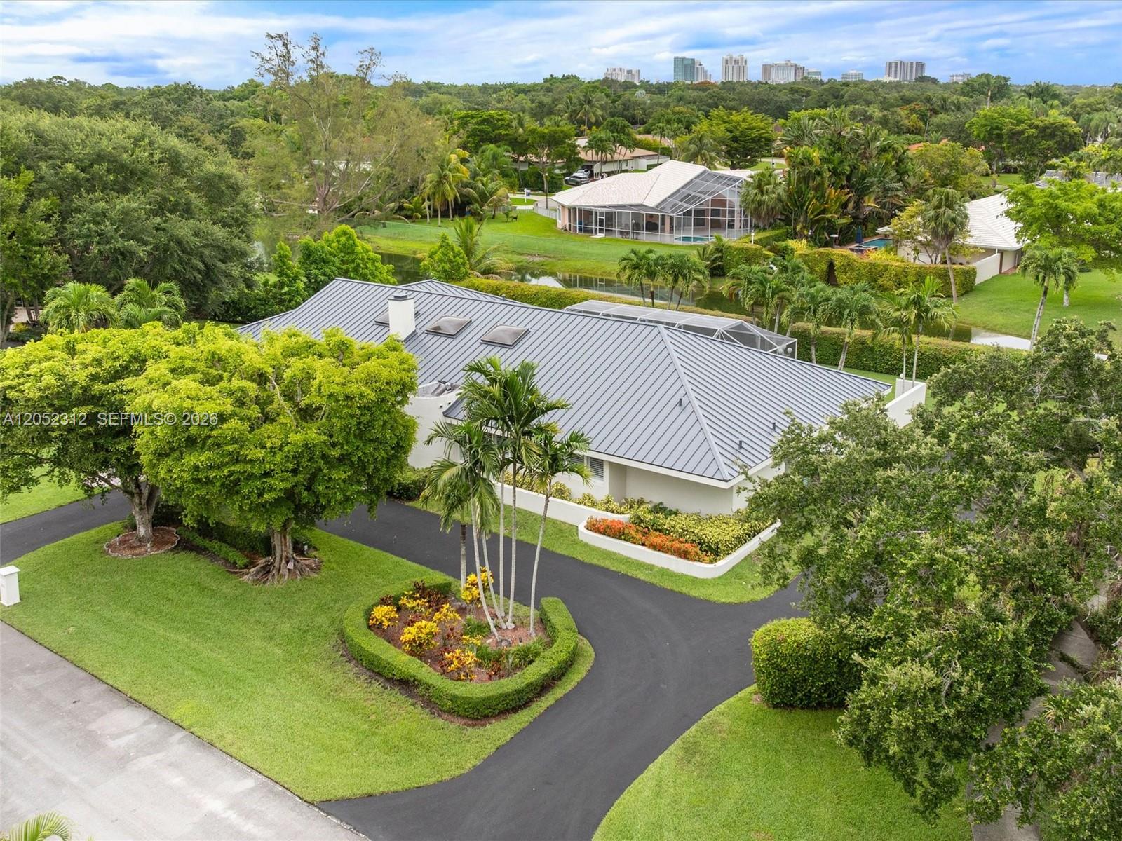An aerial view shows a house with a gray metal roof, circular driveway, and landscaping — 10321 SW 89th Ave, Miami FL 33176, MIAMI, FL