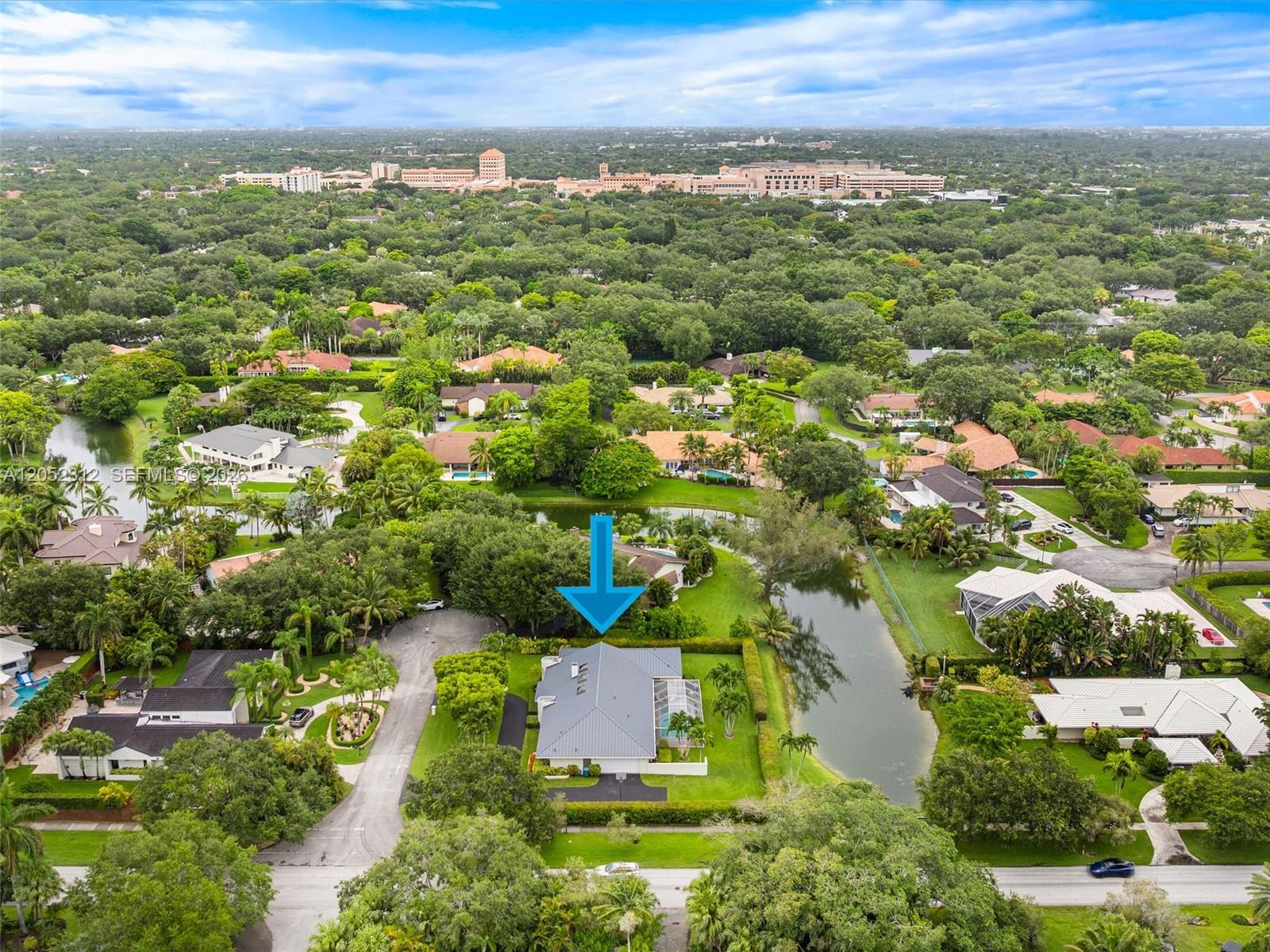 An aerial view shows a house with a grey roof situated near a small lake — 10321 SW 89th Ave, Miami FL 33176, MIAMI, FL