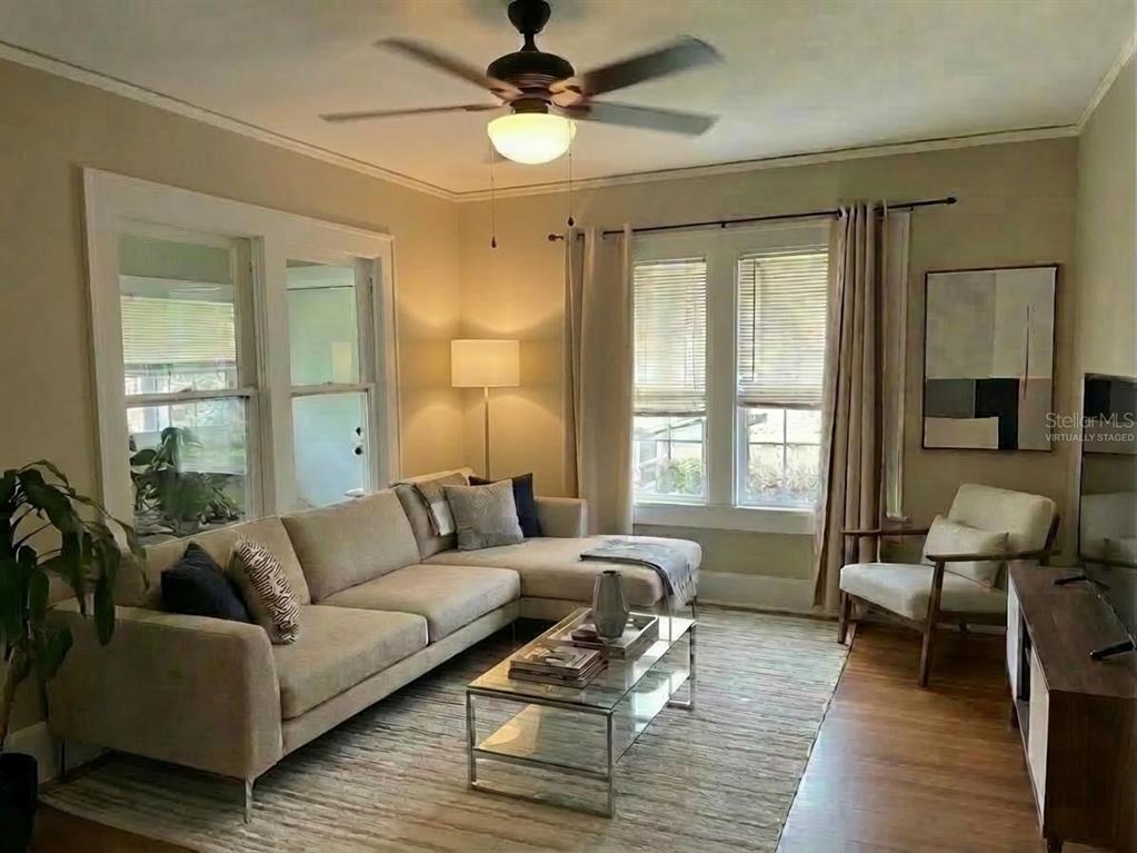 A living room features a beige sectional sofa, glass coffee table, and a ceiling fan — 1601 11 STREET N, ST PETERSBURG, FL