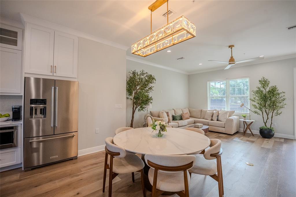 A dining area with a round marble table and a living room with a sectional sofa — 141 SE WATULA AVENUE, OCALA, FL