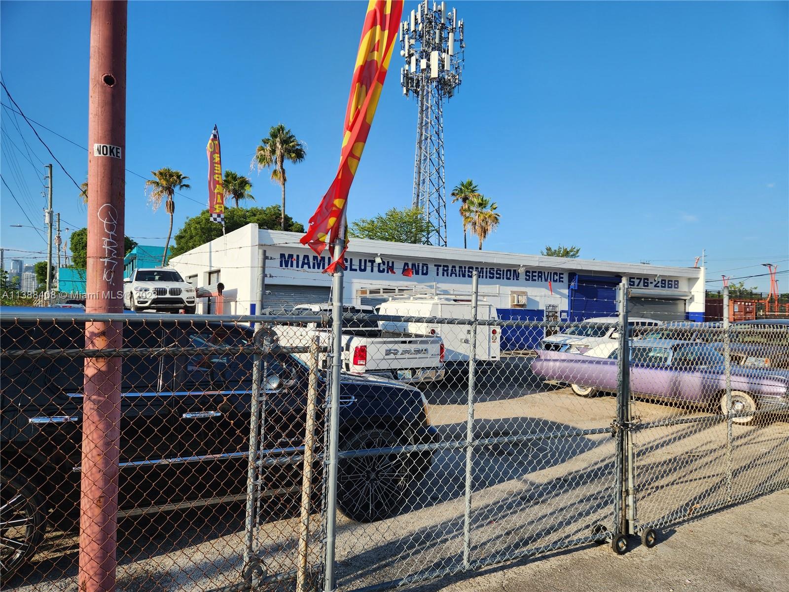 The exterior of a Miami Clutch and Transmission Service building features a chain-link fence — 60 NW 20th St, Miami FL 33127, MIAMI, FL