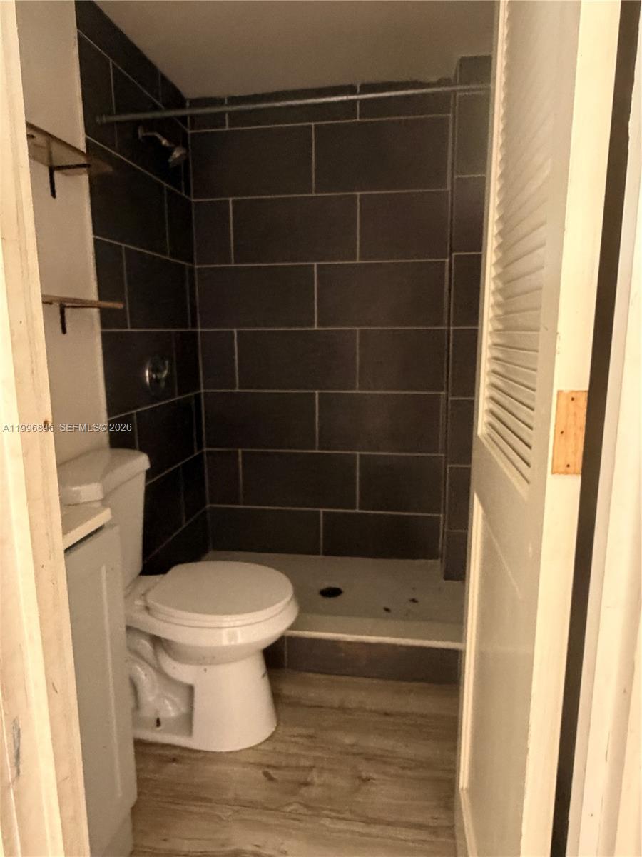 A small bathroom features a walk-in shower with dark gray tiles and a white toilet — 634 SW 10th Ave, Miami FL 33130, MIAMI, FL