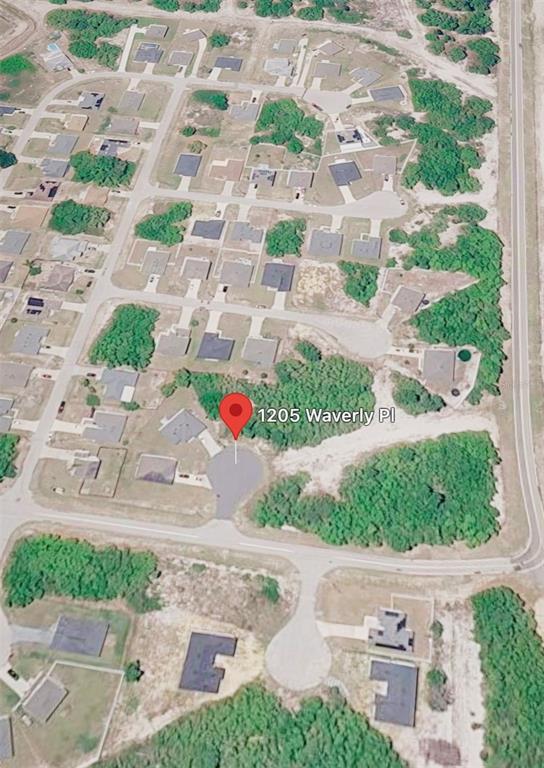 An aerial view shows a residential neighborhood with houses and a cul-de-sac — 1205 WAVERLY PLACE, KISSIMMEE, FL