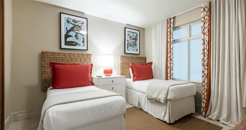 A bedroom features two twin beds with woven headboards, red pillows, and a shared nightstand — 500 PLANTATION DR. UNIT 304, DORADO, PR