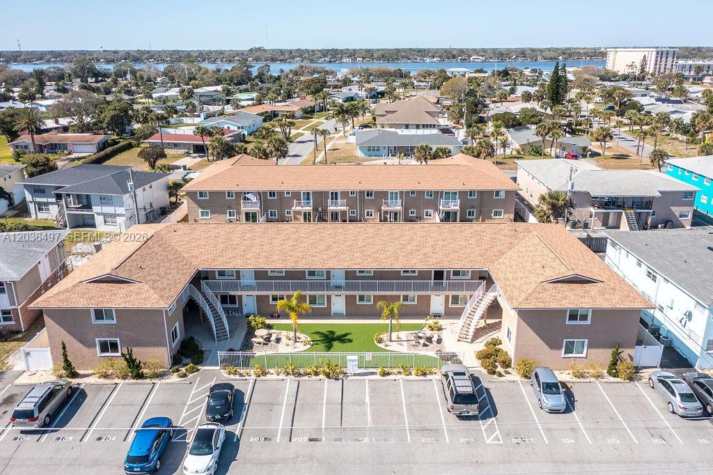 An aerial view shows a two-story apartment building with a central courtyard and parking lot — 2550 Tulane Ave # 202, Daytona FL 32118, DAYTONA, FL