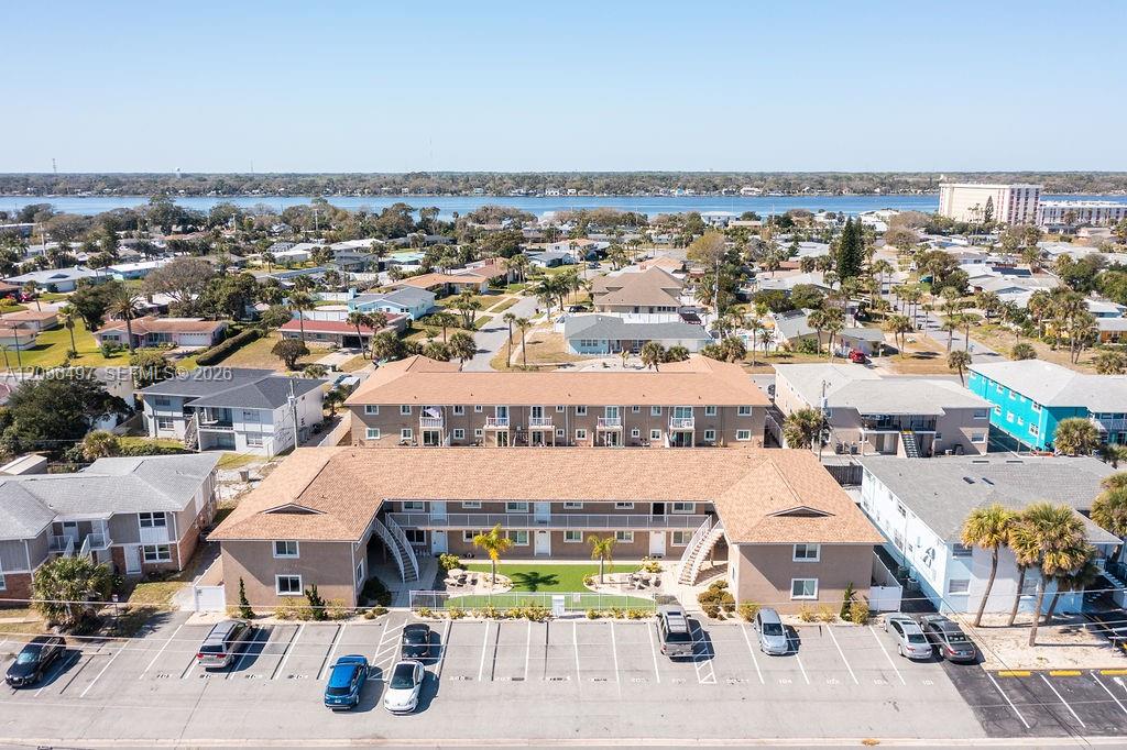 An aerial view shows a tan, U-shaped apartment building with a parking lot in front — 2550 Tulane Ave # 202, Daytona FL 32118, DAYTONA, FL